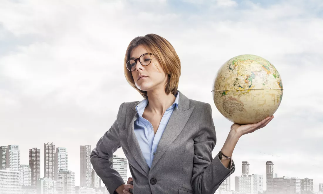 serious-employee-holding-globe