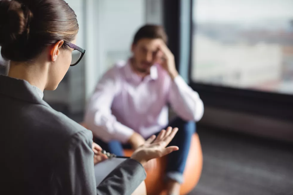 counselor-interacting-with-unhappy-man(2)