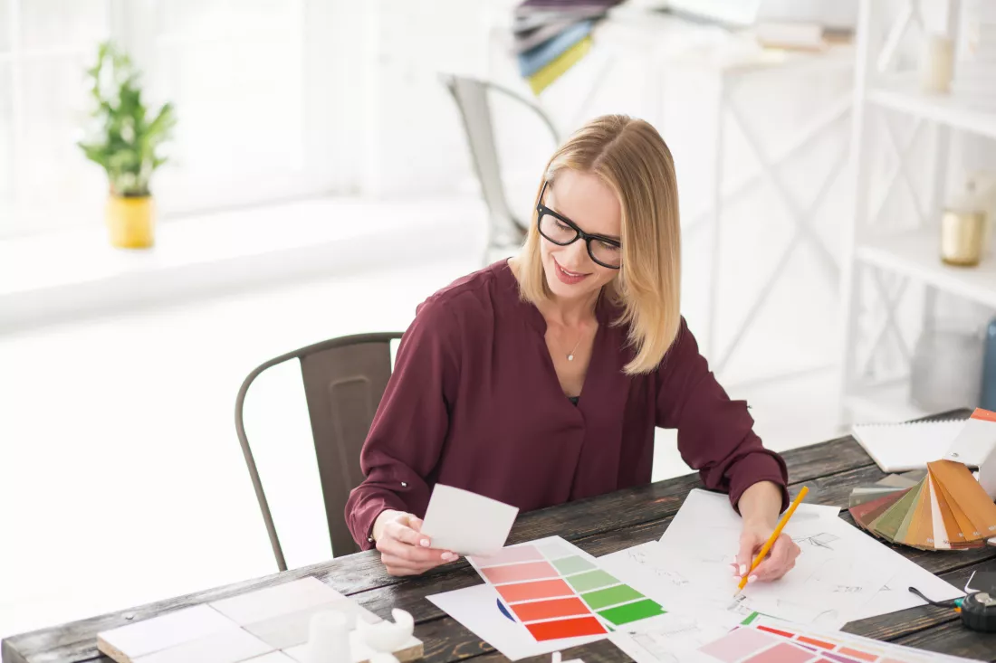 little-think-musing-female-designer-sitting-table-while-noting
