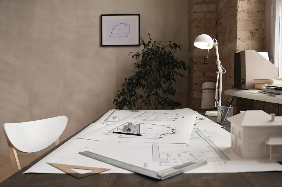 empty-minimalistic-office-with-plant-near-wall-blueprints-rulers-lamp-d-model-building-table