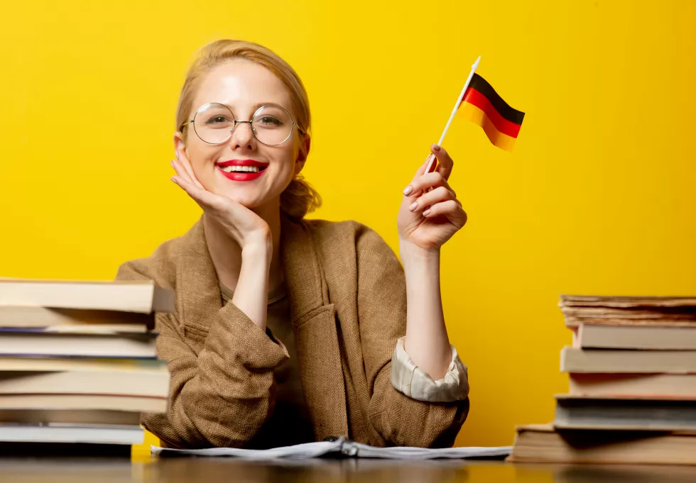 style-blonde-woman-sitting-table-with-books-flag-germany-yellow(1)