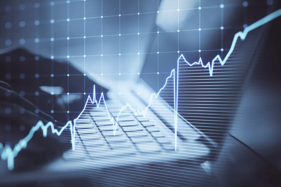 close-up-hands-using-laptop-kyeboard-with-growing-blue-financial-forex-chart-blurry-background-stock-economy-market-trade-concept-double-exposure