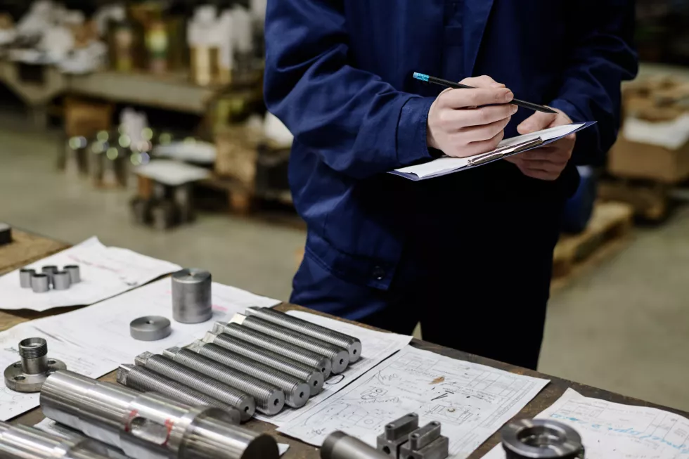 unrecognizable-specialist-checking-metal-parts