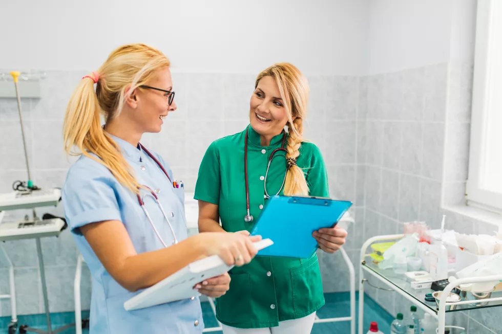 two-nurses-standing-maternity-ward-checking-out-some-documents