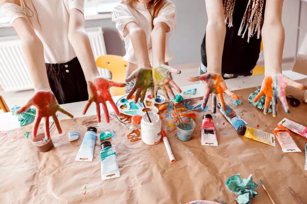 children-demonstrating-their-palms-painted-with-watercolor