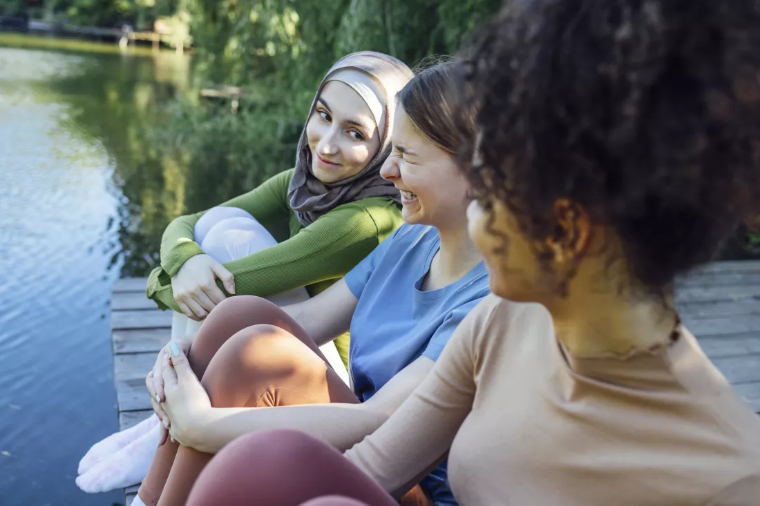 side-view-mother-daughter-sitting-lake