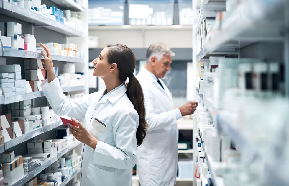 cropped-shot-two-pharmacists-checking-products-while-working-together-dispensary