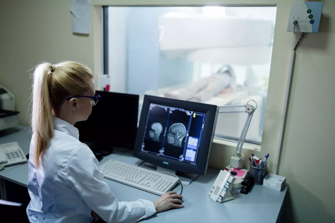 radiologist-analyzing-brain-mri-scan-results-patient-computer-monitor-control-room