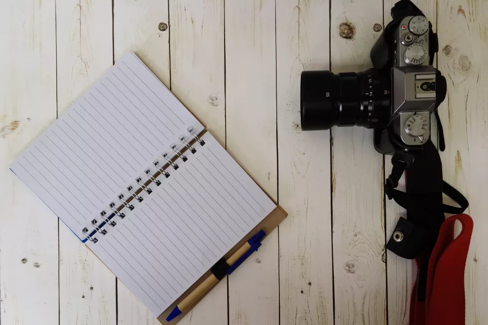 directly-shot-camera-diary-wooden-table