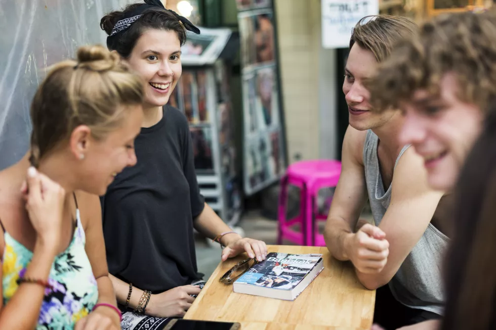 group-tourists-sitting-ordering-food