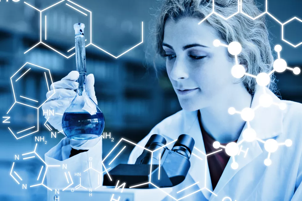 science-graphic-against-smiling-student-looking-blue-liquid