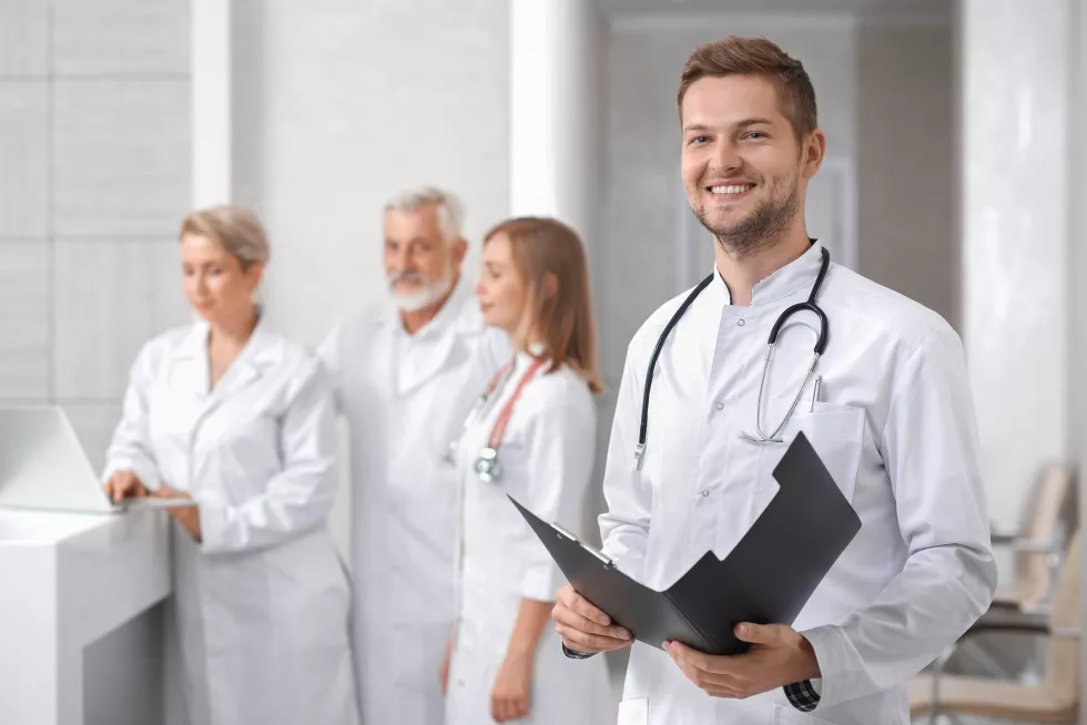 handsome-doctor-posing-group-therapists-standing