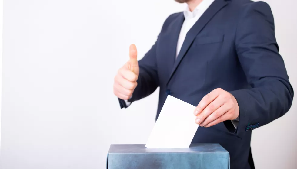 midsection-man-holding-umbrella-against-white-background