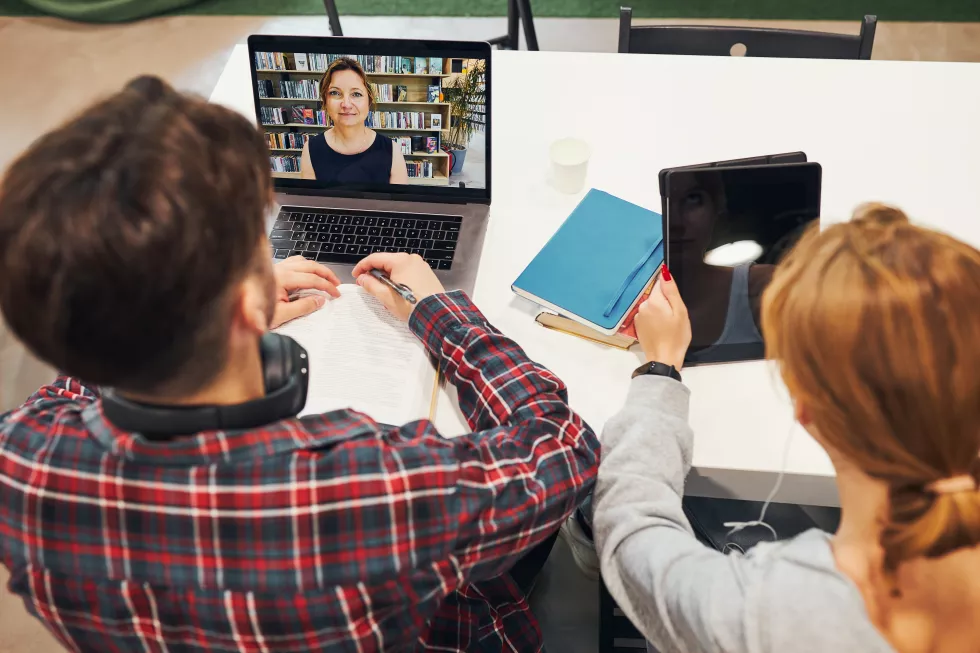 students-learning-library-young-man-having-video-class-laptop-students-studying-exams