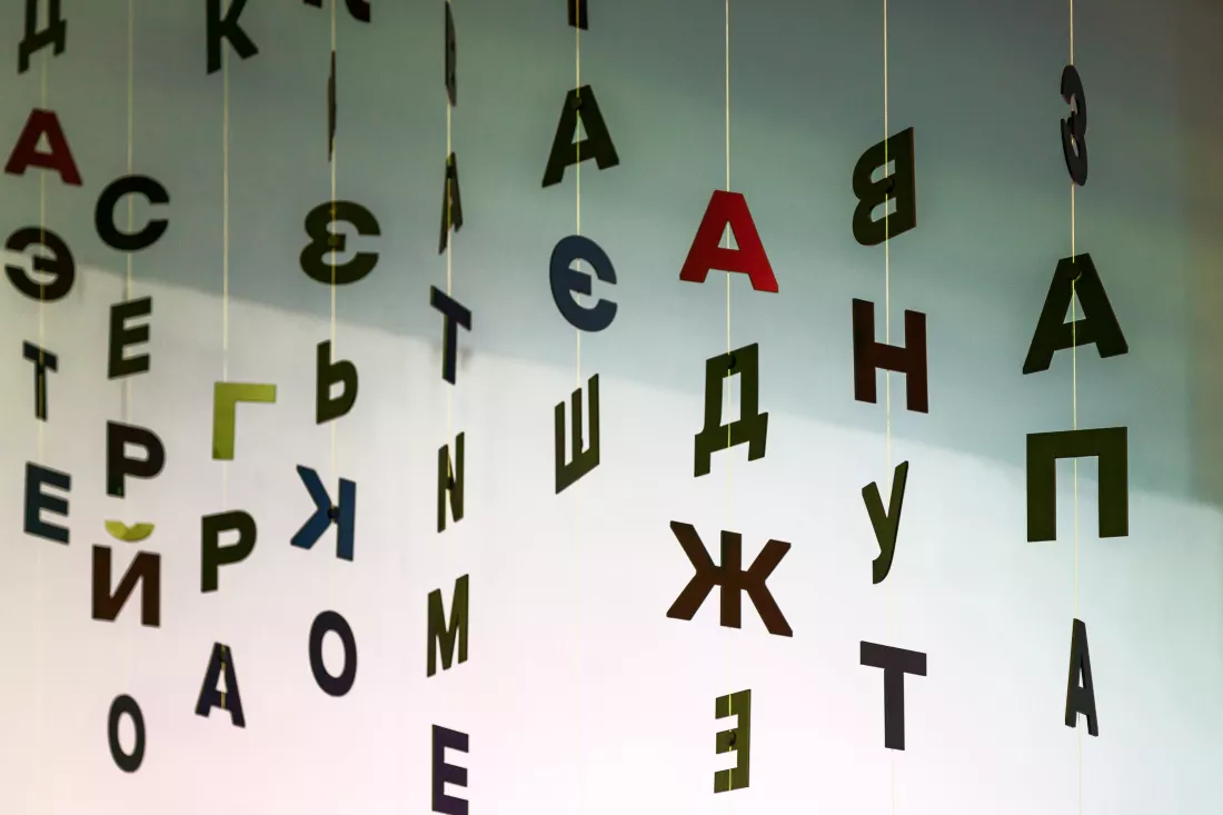 indoor-decorations-from-black-letters-hanging-threads-background-white-wall