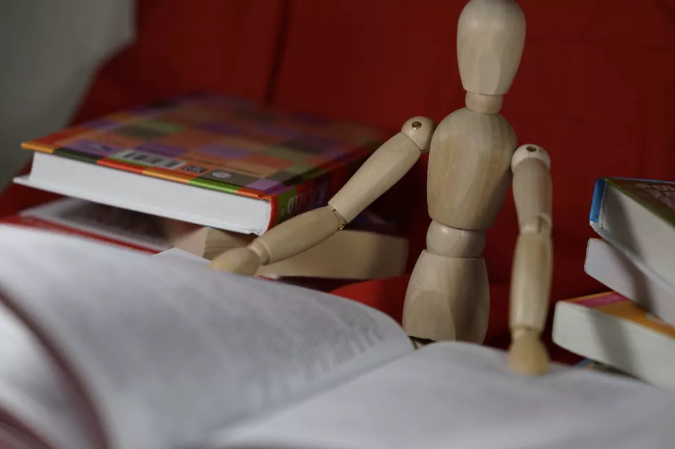 wooden-figurine-with-open-book
