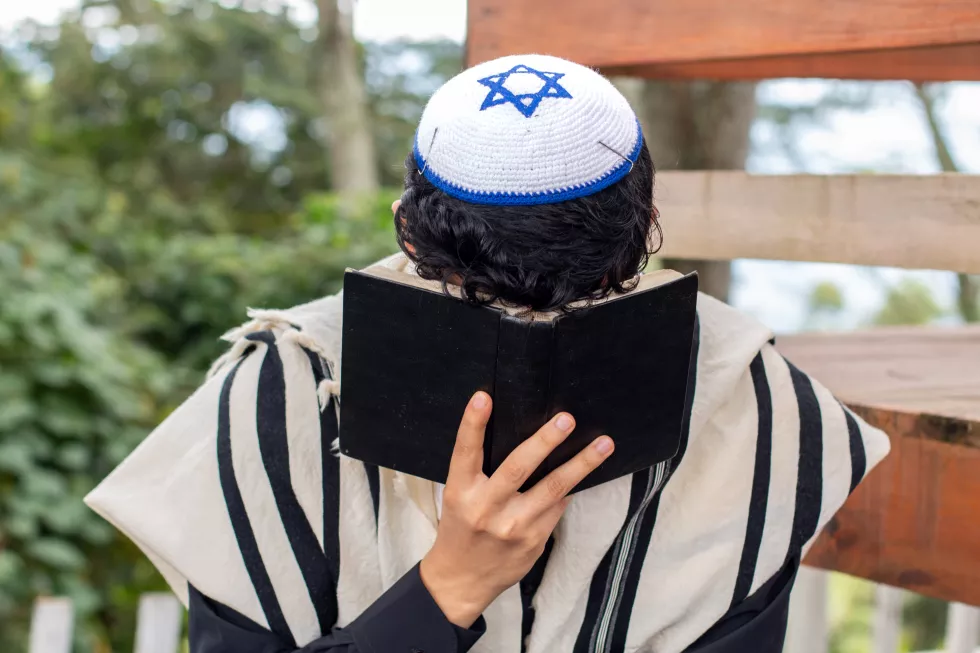 frontal-view-jew-praying-his-god-curving-his-face-with-siddur