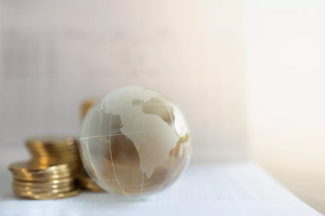 global-business-money-financial-concept-closeup-glass-world-ball-with-stack-gold-coins-bank-passbook-with-copy-space