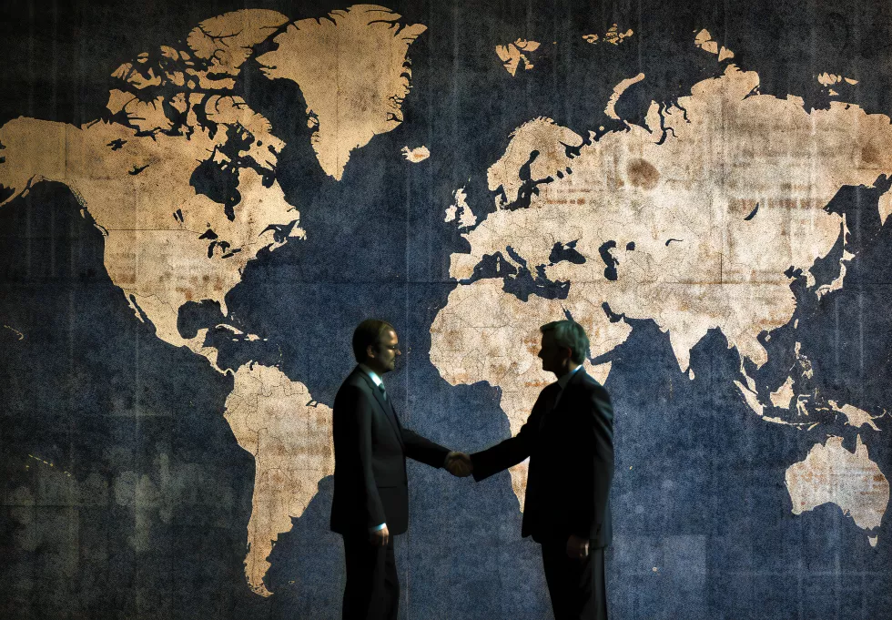 two-business-men-shaking-hands-world-map