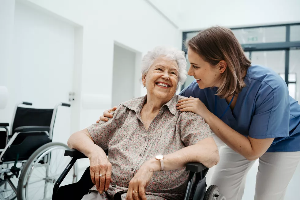 portrait-nurse-senior-patient-talking-hospital-corridor-emotional-support-elderly-woman