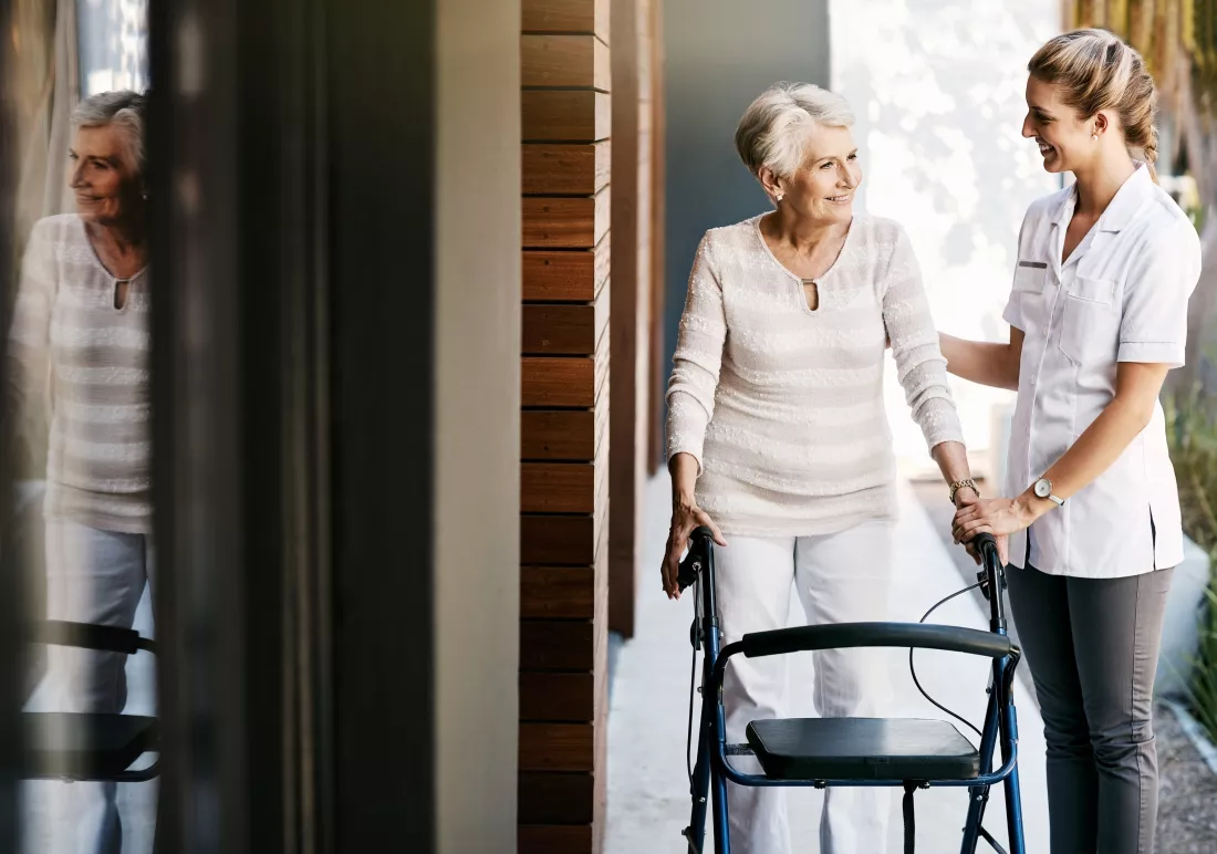 senior-woman-caregiver-outside-with-walker-movement-wellness-care-with-healthcare-employee-nursing-home-rehabilitation-walking-support-with-nurse-physical-therapy-happy-people