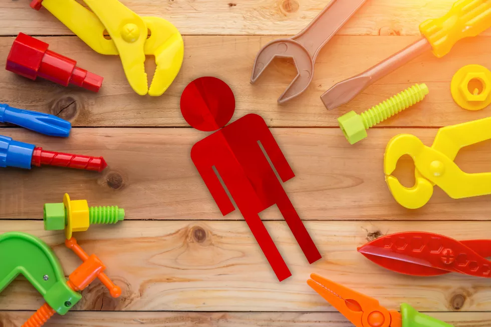 directly-shot-various-colorful-toys-human-representation-wooden-table