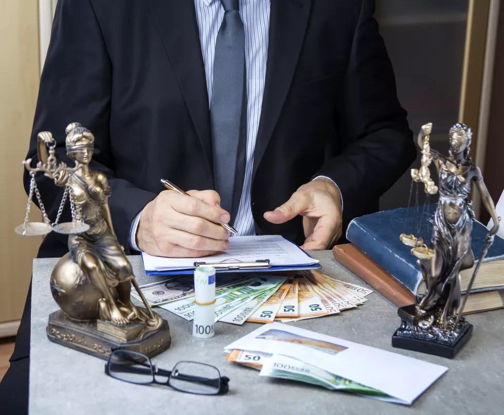 midsection-lawyer-writing-paper-while-sitting-office