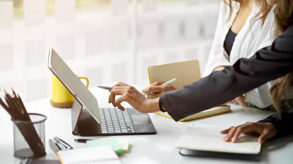 midsection-woman-using-laptop-table