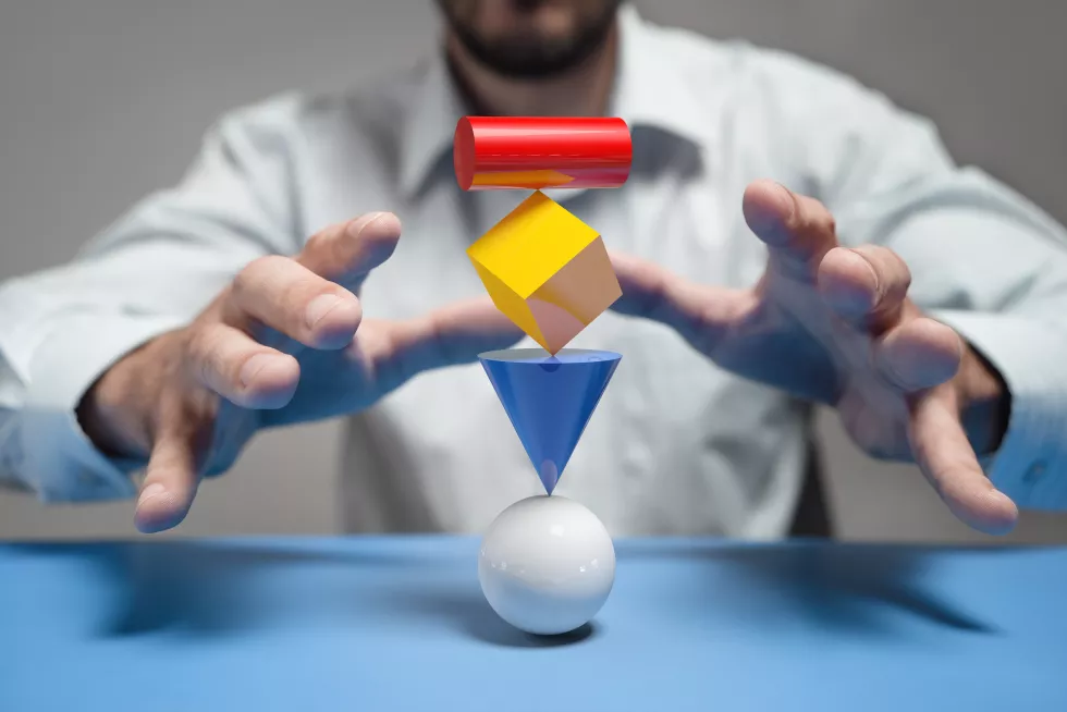midsection-man-catching-toy-blocks-stacked-table