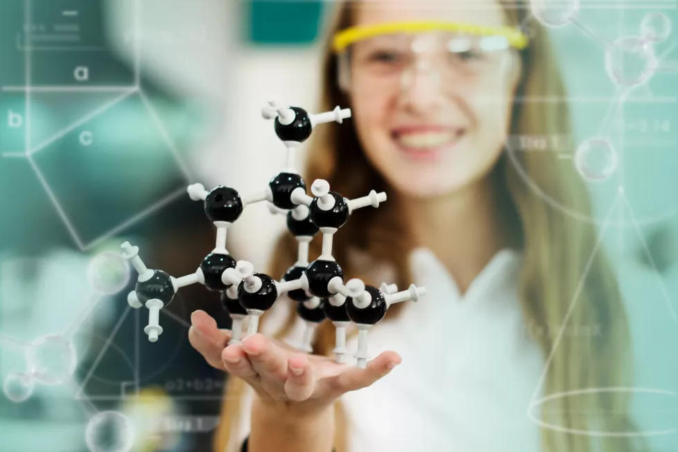 female-student-holding-molecule-model-2