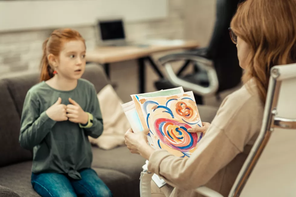 childs-painting-selective-focus-professional-female-psychologist-holding-childs-painting(3)