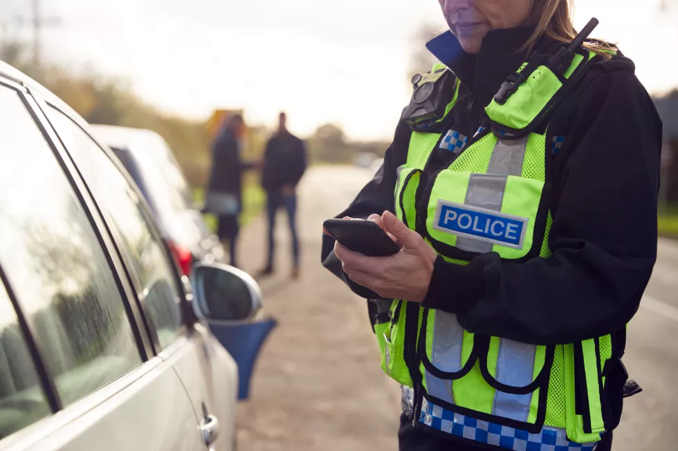 female-traffic-police-officer-recording-details-road-traffic-accident-mobile-phone